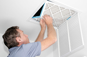 ai_ac_maintenance3 Man changing HVAC filter