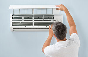Man installing ductless AC