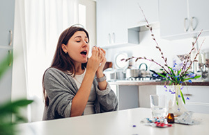 Woman drinking coffee at kitchen table