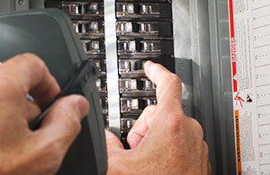 Person turning off circuit breaker