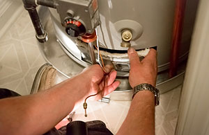 Person repairing a water heater
