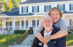 Older couple in front of their home