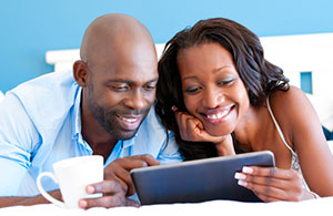 Couple smiling looking at an iPad