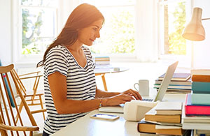 Woman working at desk on a laptop