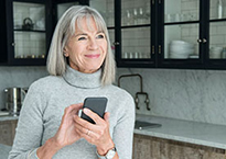 Woman smiling holding phone