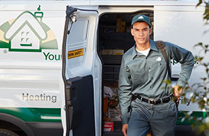 Wallace service tech in front of service van